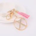 Detailed close-up of the stylish metal rhinestone letter keychain with a pink tassel. - Letter X