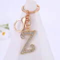 Close-up detail of the dazzling rhinestone letter Z keychain pendant in polished gold alloy. - Letter Z