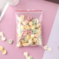 Close-up of transparent PE self-sealing bag filled with colorful butterfly pasta - Pack of 200 (10x15cm, 6 Silk) / Red Border