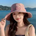 Pink denim bucket hat with plaid frayed trim, ideal for summer beach sun protection. - Pink