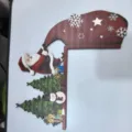 Detailed view of Santa Claus wooden door corner frame with snowman and tree designs - Right Side