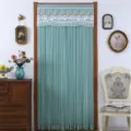 Detail view of the elegant green mesh door curtain with white lace embroidery for room decor. - Jin Simei Green Privacy Door Curtain