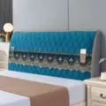 Close up of blue quilted bed headboard cover detail with decorative lace storage pockets. - Royal Blue