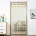 Detail view of the lace double-layer mesh door curtain hanging in home doorway scene. - 90*220cm / Nordic Beige