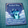 Close-up of a blue resin elephant pocket hug on an inspirational message card - Elephant