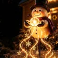 Festive Christmas snowman garden light with glowing orb and star snowflake motifs - Christmas Snowman Solar Light