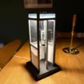 Detailed view of a vintage miniature lighted telephone booth on a wooden table surface - Black Vintage Style / Wired Power Version