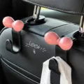 Cute pink bow car seat back hook for hanging bags and organizing interior accessories securely. - Black Car Hooks with Pink Dopamine Bows (2 Pieces)