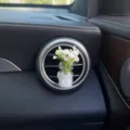 Car air vent perfume clip with white artificial baby's breath flowers in a mini glass bottle decor. - Jasmine / White