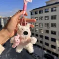White plush puppy keychain, cute fluffy dog bag charm with pink sweater and tiny bunny toy. - Pink Clothes Hugging Rabbit Westie Pink Braided Lanyard