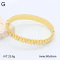 Bracelet jonc en acier inoxydable doré, détails géométriques incrustés de strass, 60x8mm. - Or 18 carats / 12