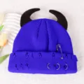 Close-up detail of knitted beanie featuring cute devil horns, metal rings, and punk safety pin. - Adjustable / Sapphire Blue