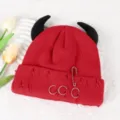 Red knit beanie detail showcasing black devil horns, distressed holes, and metal ring piercings. - Adjustable / Burgundy