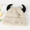 Cute devil horn knitted beanie hat with metal pin and distressed holes for autumn and winter. - Adjustable / Beige