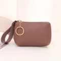 Compact litchi pattern leather coin purse with wrist strap and gold keychain zipper. - Purple