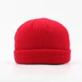 Solid color red knitted beanie hat for men and women, warm winter casual docker cap style. - Red
