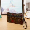 Vintage embossed floral leather clutch wallet with dual zippers and wrist strap for women. - Zipper Style / Brown