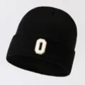 Black knit beanie hat for men and women, featuring a stylish white letter O patch. - Adjustable / Letter O
