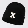 Black knit beanie for men and women, featuring a stylish white letter patch for a casual look. - Adjustable / Letter X