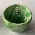 Handmade green pottery herb stripper bowl featuring holes for fresh kitchen herbs - Green Glaze