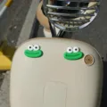 Close-up detail shot of cute funny green monster eyes stickers for electric scooter front. - Green