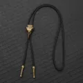 Detailed macro view of an antique bronze bird skull bolo tie with braided leather cord. - Bronze