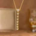 Close-up of elegant gold heart pendant necklace with shimmering clear zircons - Heart White Zirconia Long Style (9493)