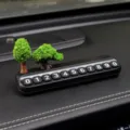 Car temporary parking number plate with miniature tree ornament for dashboard interior use. - Pine and Cypress + Black Parking Plate