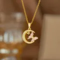 Detailansicht einer vergoldeten Kette mit Zirkonia-Mond und rosa Schmetterlingsanhänger. - Mond Schmetterling Stil (9411)