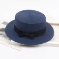 Navy blue flat top straw hat with elegant black ribbon bow, perfect for summer beach and sun. - M (56-58cm) / Navy Blue