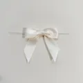 Elegante fiocco in nastro di satin beige con legatura, ideale per confezioni regalo. - 2.5x9x9cm / Bianco avorio