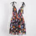 Detail shot of the dazzling sequin floral embroidery and deep V-neck design on the dress. - Black