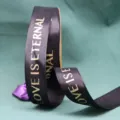 Black ribbed ribbon detail featuring gold foil stamped lettering for floral gift wrapping - Black