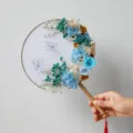 Preserved dried flower round fan variant with blue and white floral art and elegant wooden handle. - Canghai Fan Material Pack