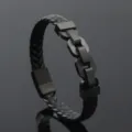 Close-up of black braided leather bracelet with matte black stainless steel links. - Black