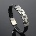 Macro detail of braided black leather bracelet with stainless steel chain links - Steel