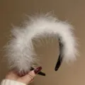 Fluffy white feather headband detail, soft ostrich feather texture on a black band close-up. - Wide Headband / White