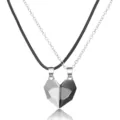 Detail of magnetic wishing stone couple necklaces with heart pendants in black and white - Black+White