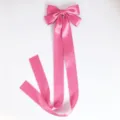 Pink satin bow detail with long flowing ribbon, sweet style hair accessory close up. - Duckbill Hair Clips / Rose Red