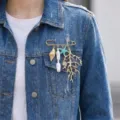 Detailed view of an ocean-themed brooch with pearls and coral on a denim jacket. - Coral Starfish Style (26Y0003)