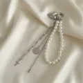 Dettaglio della catena per borsa con ciondolo a cuore, perle sintetiche e nappe metalliche - Stile Moneta Croce Argento (XK26Y0514)