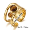 Dettaglio di un anello vintage in acciaio inossidabile dorato con pietre occhio di tigre - Stile Traforato Occhio di Tigre