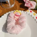 Pink plush hair scrunchie featuring a quirky big-eyed monster character decoration - Cute Baby Pink