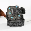 Close-up of western cowboy belt with embossed floral patterns and turquoise buckle - Black