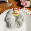 Soft plush grey scrunchie hair tie featuring a cute green monster charm on a plate - Cute Baby Green