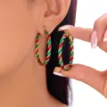 Detailed view of large Christmas red and green twisted glitter hoop earrings for women - 红绿金三色扭曲条纹款