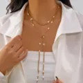 Elegant gold-tone Y-shaped layered necklace with delicate white faux pearl accents - Gold Pearl Tassel Style (NC25Y1070-1)