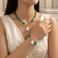 Model wearing elegant green stone beaded necklace and bracelet with baroque pearl pendant - Green Necklace Bracelet Set (XK26Y0578-2)