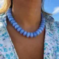 Detail of blue water-ripple resin beaded choker necklace worn on neck - Sky Blue