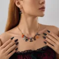 Halloween necklace with pumpkin and ghost charms worn by a model in a gothic style decor - Necklace Earring Set Style (NC26Y0380)
